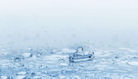 Spalsh watyer.High-speed shooting, a blue backgroundの写真素材