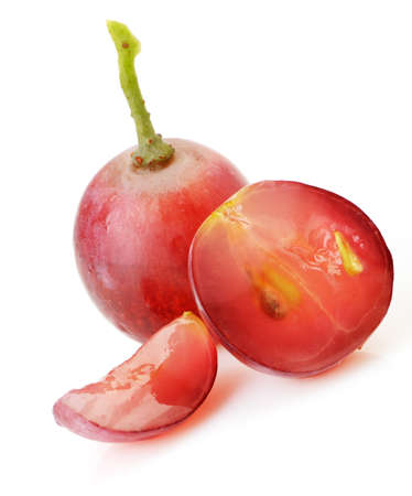 red grapes. Cut on segments grapes berry. It is isolated on a white backgroundの写真素材