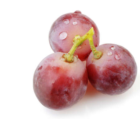 Three berries of red  grapes close up. It is isolated on a white backgroundの写真素材