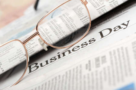 Eyeglasses lie on the newspaper with title Business day. A photo close up. Selective focusの写真素材