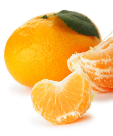Segments and the whole tangerine. A detailed photo of fruit on a white backgroundの写真素材