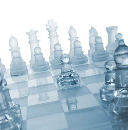 Glass chess. The first move. Blue toned.の写真素材