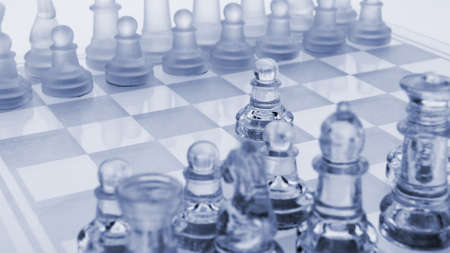Glass chess. The first move. Blue toned.の写真素材