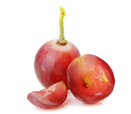 red grapes. Cut on segments grapes berry. It is isolated on a white backgroundの写真素材