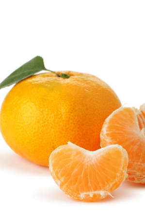 Segments and the whole tangerine. A detailed photo of fruit on a white backgroundの写真素材