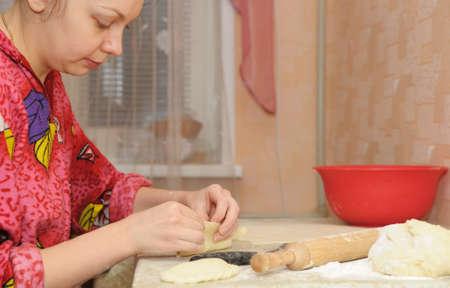 The woman prepares a pie. House conditions, cookingの写真素材