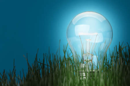 Shone electric lamp in a grass. A blue backgroundの写真素材