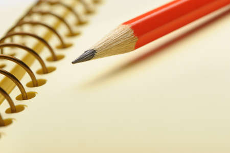 Notebook yellow paper and red pencil. Photo closeup. Selective focusの写真素材