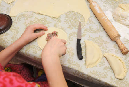 The woman prepares a pie. House conditions, cookingの写真素材