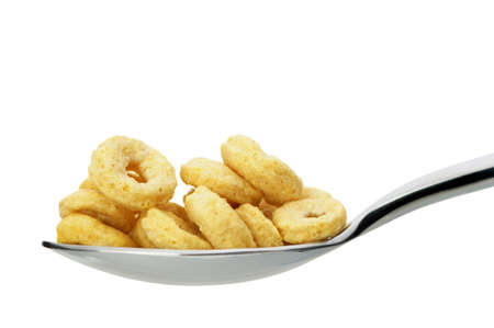 Ð¡ornflakes. A dry breakfast in a spoon. It is isolated on a white backgroundの写真素材