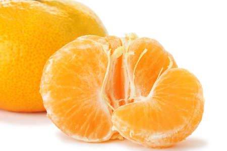 Segments and the whole tangerine. A detailed photo of fruit on a white backgroundの写真素材