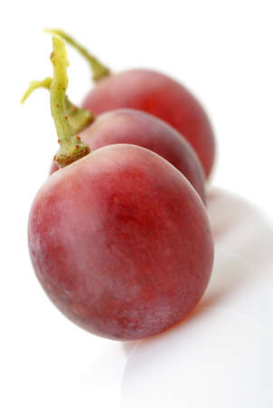 Three berries of red grapes abreast. It is isolated on a white background