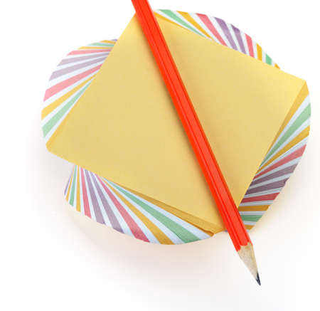 Paper note and a red pencil. It is isolated on a white backgroundの写真素材