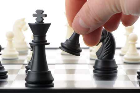 Pawn in hands over a chessboard. Selective focusの写真素材
