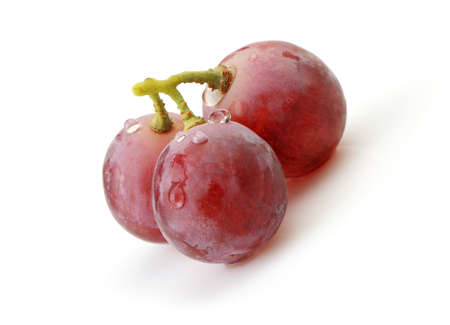 Three berries of red  grapes close up. It is isolated on a white background