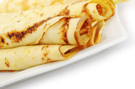 Crepe roll up a tubule on a plate. It is isolated on a white background.の写真素材