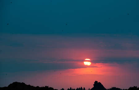 Picturesque sunset.Above mountain and a wood. Silhouette the imageの写真素材