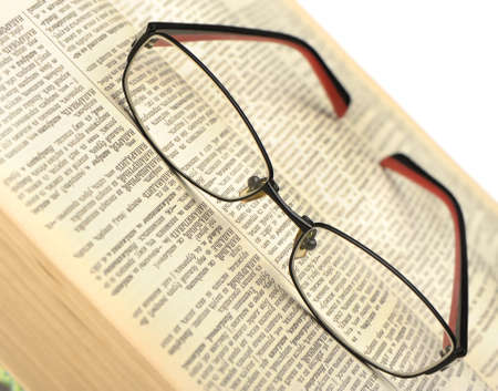 Eyeglasses on the old thick book. A photo close upのeditorial素材