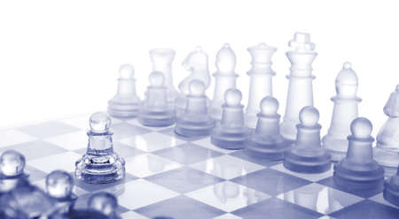 Glass chess. The first move. Blue toned.の写真素材