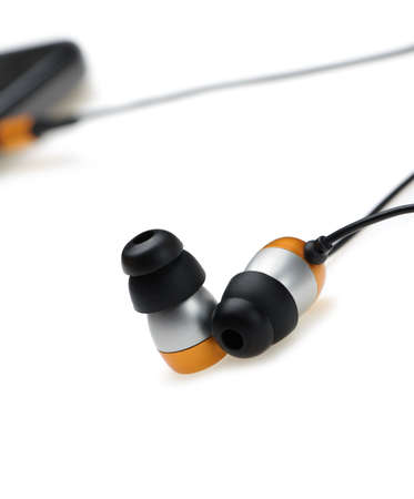 in ear headphone with mobile audio player on bokeh backgroundの写真素材