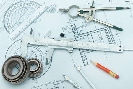 The plan industrial details, a protractor, caliper, divider and bearing. A photo closeup. Blue toningの写真素材