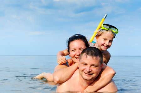 Happy family in the sea. Mum, the father and the daughterの写真素材