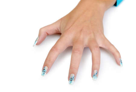 Female hand with manicure close up. Drawing of a branch with blue flowers. It is isolated on a white background.の写真素材