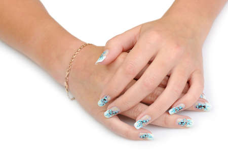 Female hands with manicure close up. Drawing of a branch with blue flowers. It is isolated on a white background.の写真素材