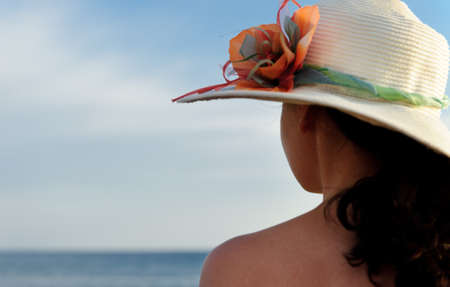 The girl in a hat against the blue skyの写真素材