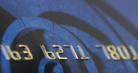 Credit card closeup. Selective focus on gold numbersの写真素材
