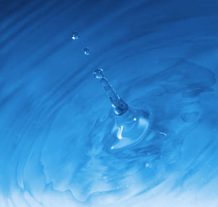 Drop falling in water. High-speed shooting, a blue backgroundの写真素材