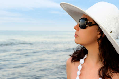 Portrait of the young woman in a hat. Seacoast, a close upの写真素材