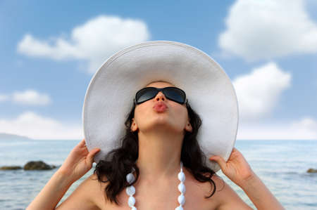 Portrait of the young woman in a hat. Seacoast, a close upの写真素材