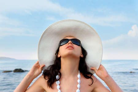 Portrait of the young woman in a hat. Seacoast, a close upの写真素材