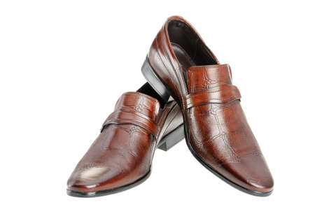 Pair of man's shoes. A red skin. It is isolated on a white backgroundの写真素材