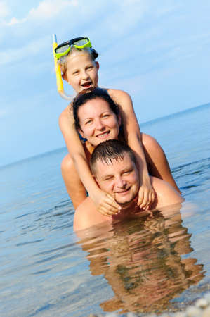 Happy family in the sea. Mum, the father and the daughterの写真素材