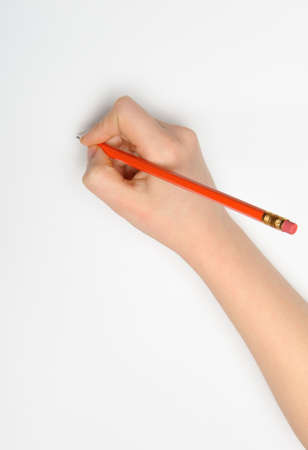 Hand with pencil. Over grey empty a paper. Imitation to writeの写真素材