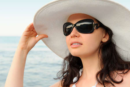 Portrait of the young woman in a hat. Seacoast, a close upの写真素材