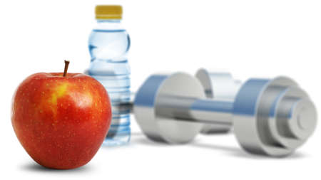 Dumbbells with an apple. Dumbbells blured on a background. It is isolated on a white backgroundの写真素材