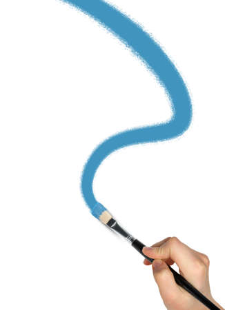 The hand with a brush draws curve  a blue paint. It is isolated on a white backgroundの写真素材
