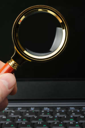 Magnifying glass in his hand and a notebook. The concept of search