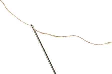 Needle and thread closeup. Isolated on white backgroundの写真素材