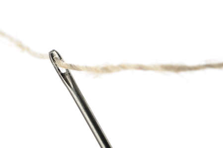 Needle and thread closeup. Isolated on white backgroundの写真素材