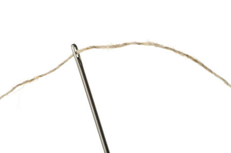 Needle and thread closeup. Isolated on white backgroundの写真素材