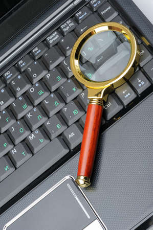 Magnifying glass and a laptop. The concept of searchの写真素材