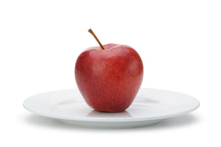Red apple on plate. Isolated on white backgroundの写真素材