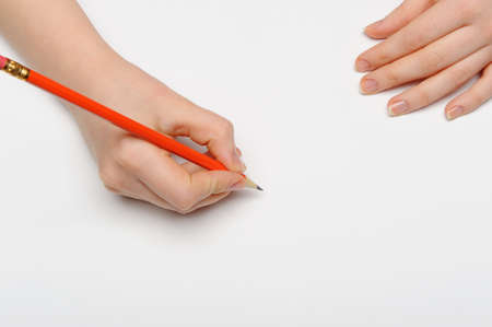 Hand with pencil. Over grey empty a paper. Imitation to write