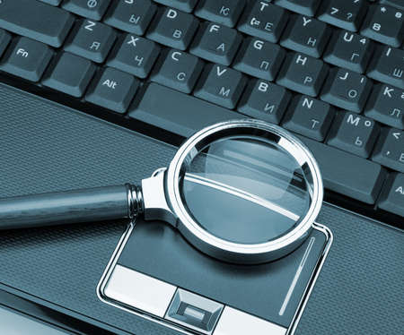 Magnifying glass and a laptop. The concept of searchの写真素材
