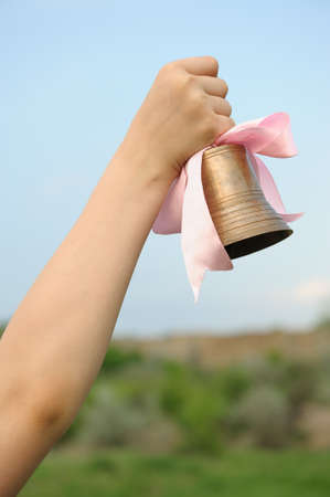 The hand with a bell. End of the academic yearの写真素材