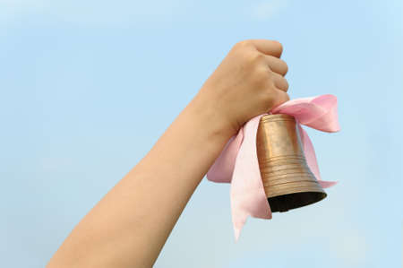 The hand with a bell. End of the academic yearの写真素材